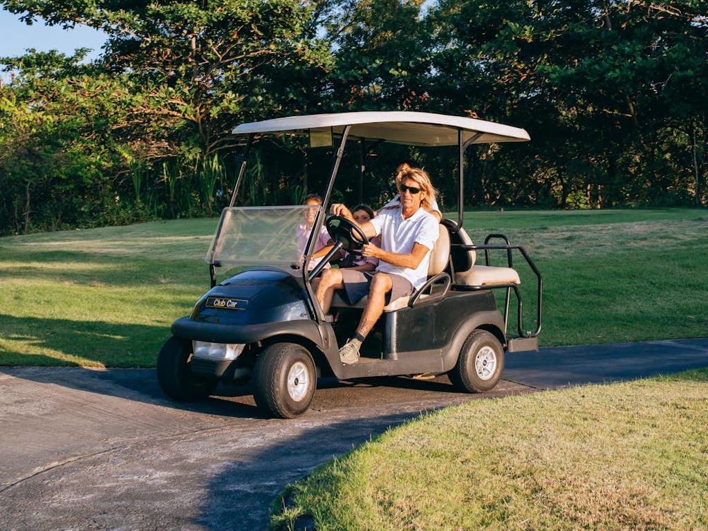 Man driving golf cart